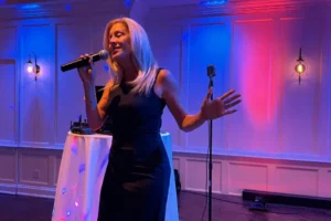 Liza performing live with a microphone and compact setup for restaurant entertainment in New Jersey