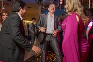 Adults laughing and dancing together during an energetic live entertainment experience