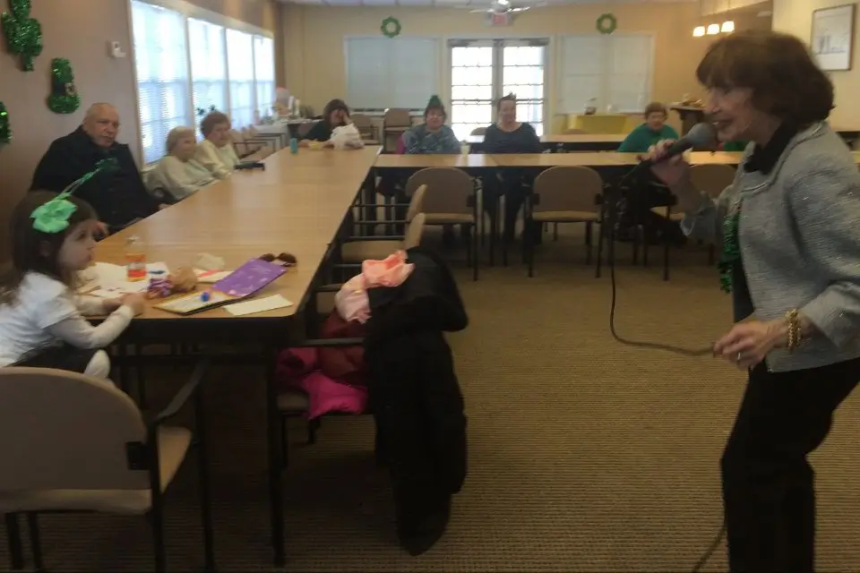Female singer performing for residents at an assisted living facility in New Jersey