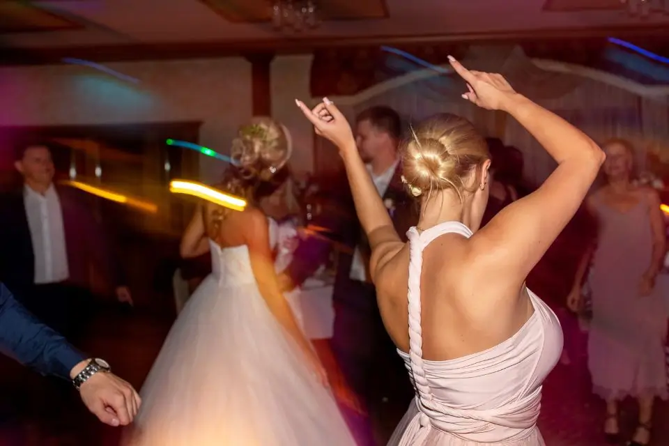 Women dancing at a wedding celebration with DJ-style party entertainment