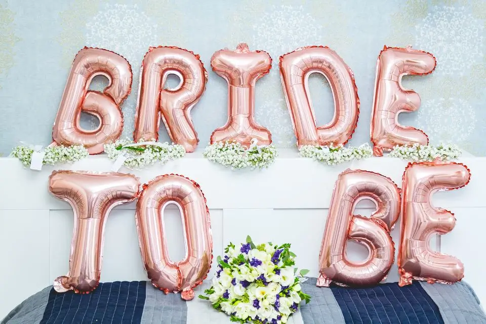 Bride-to-be balloon display and flowers for a bridal shower celebration