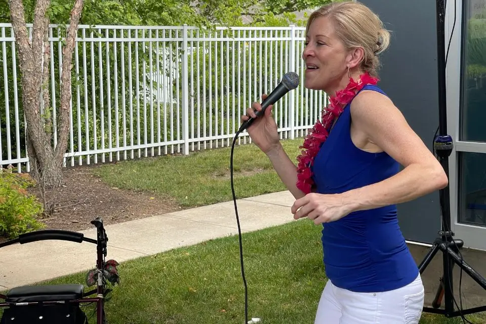 Female vocalist singing outdoors during a senior center entertainment program
