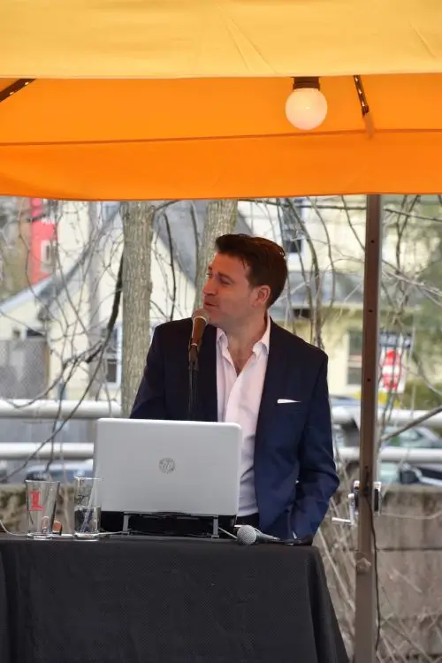 Josh providing live vocals and DJ music under a canopy at an outdoor New Jersey party