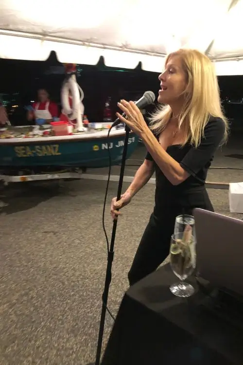 Liza performing live under a tent at an outdoor party in New Jersey
