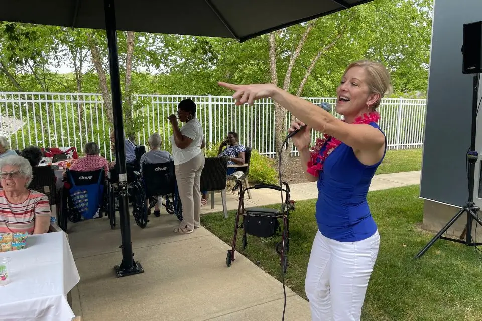 Female singer performing outdoors for residents at a senior community in New Jersey