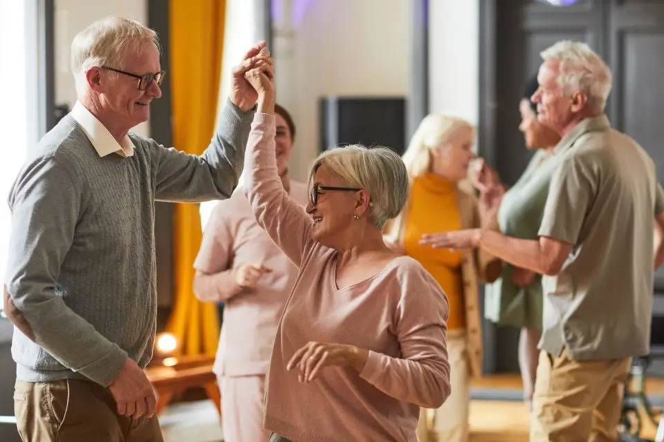 Older adults dancing together during entertainment at a senior living community