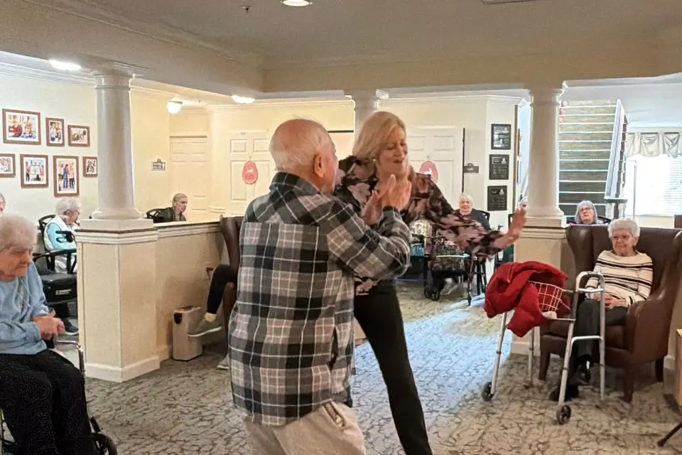 Singer engaging with residents during a live music performance at a senior living community