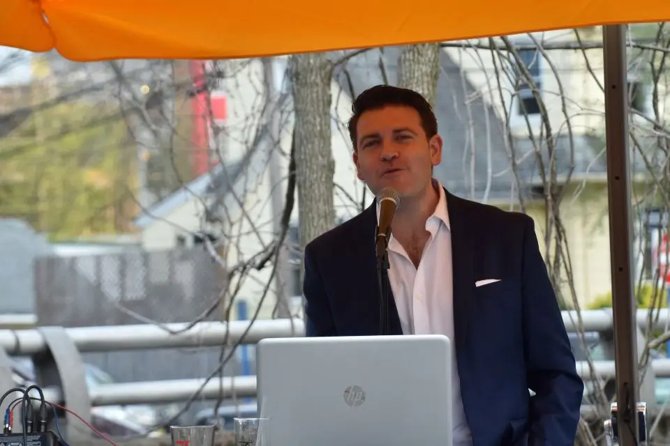 Male solo musician singing at an outdoor senior living community event